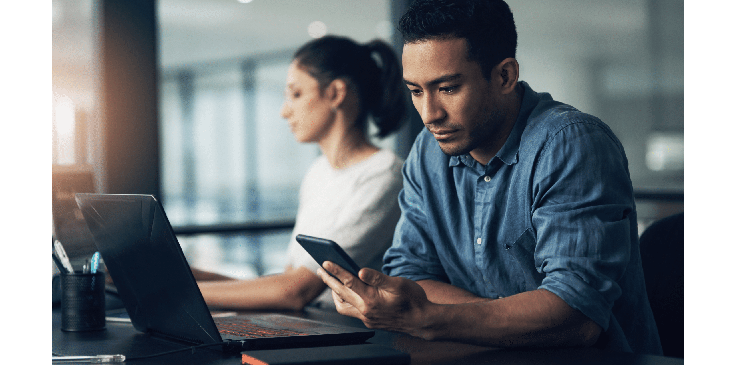 Two people at work, disconnected.